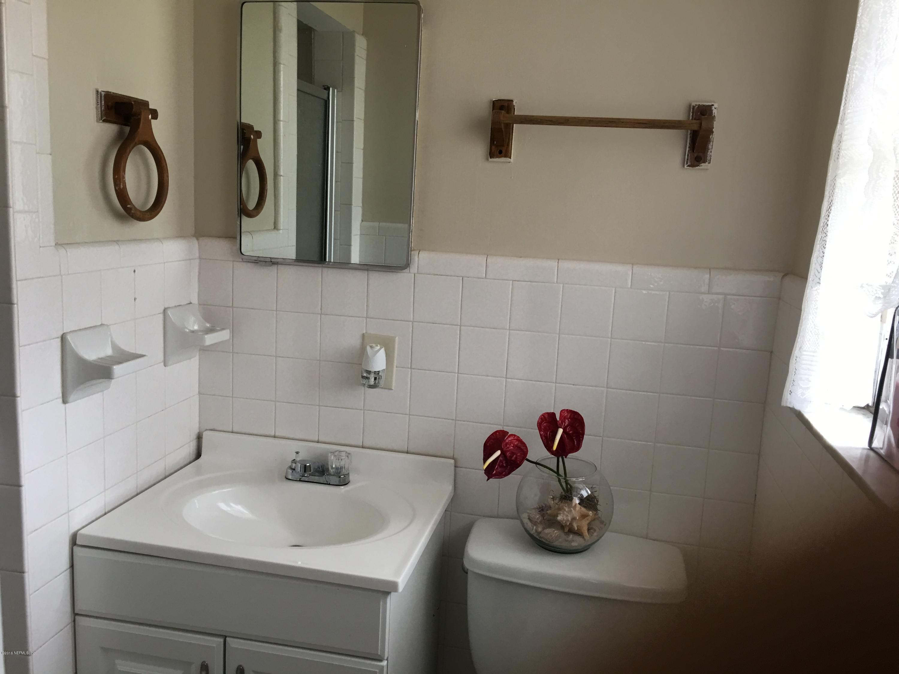 6424 Diane Road Jacksonville, FL 32277 - Photo 7 of 8 a bathroom with a sink and a mirror