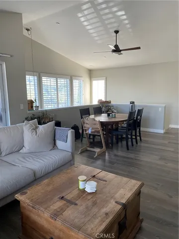 a living room with furniture a wooden floor and chandelier