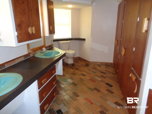 28202 Vargo Lane Elberta, AL 36530 - Photo 18 of 45 Both bathrooms are almost identical and are 19 x 9. Double vanity. Abundance of built-in cabinets. Brick floor.