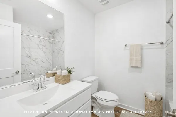 a view of kitchen with stainless steel appliances granite countertop a stove a sink a window and white cabinets