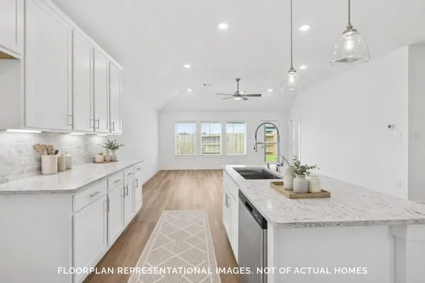 a kitchen with kitchen island a sink stainless steel appliances and cabinets