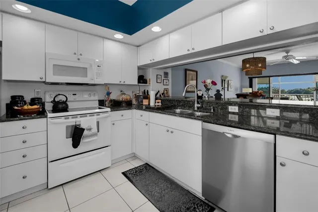 a living room with furniture a flat screen tv and a large window