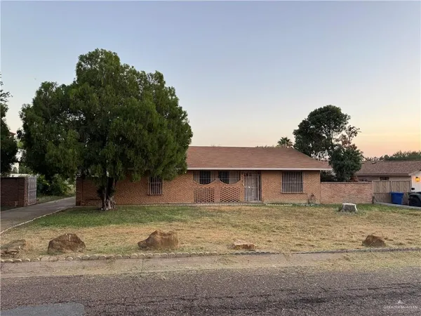 a house that has a tree in front of it