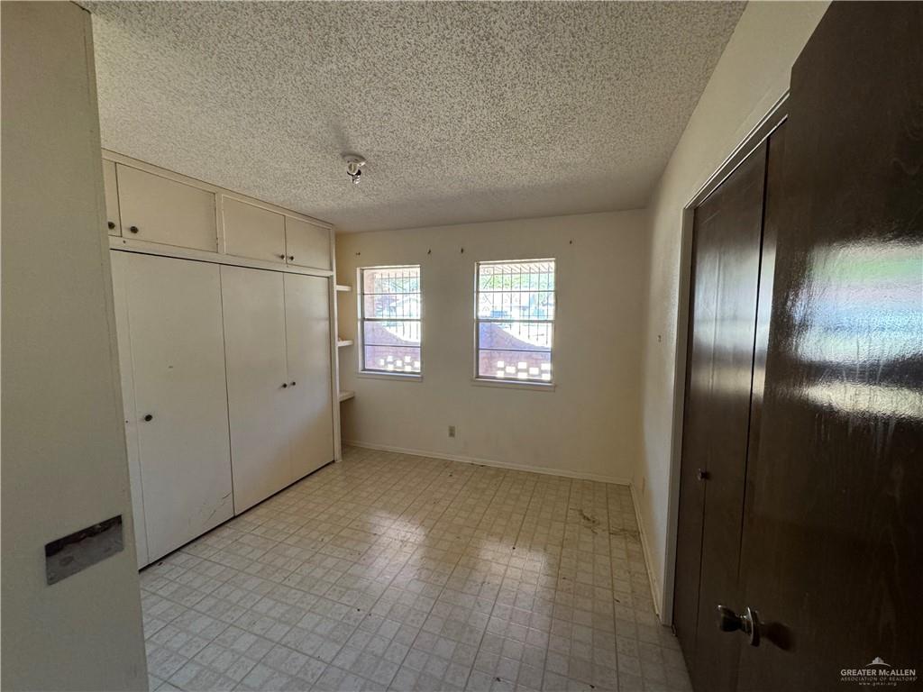 421 Longshadow Road Laredo, TX 78041 - Photo 7 of 13 a view of an empty room with wooden floor and a window