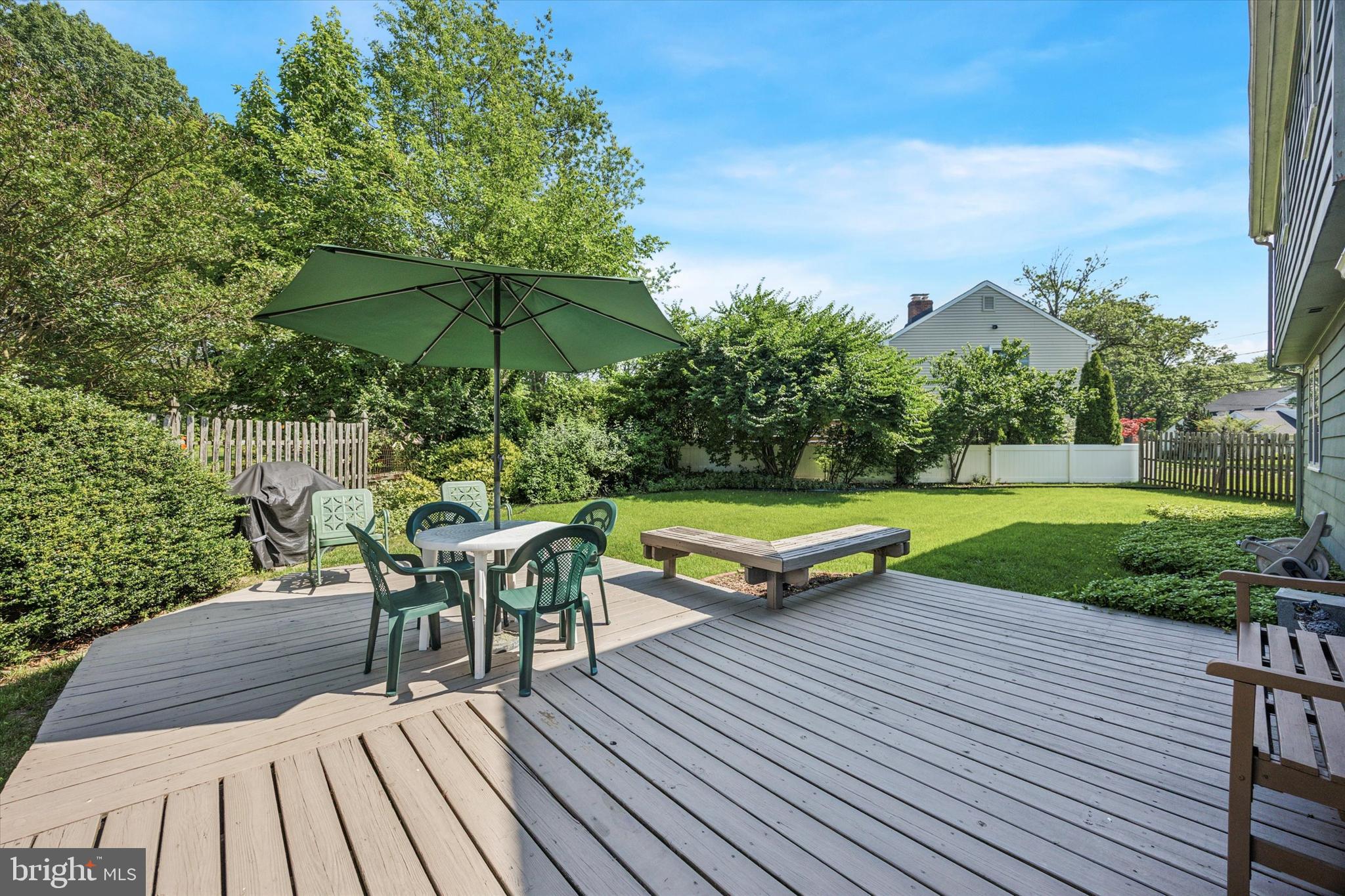 111 Wayside Drive Cherry Hill, NJ 08034 - Photo 23 of 28 a view of a deck with table and chairs under an umbrella