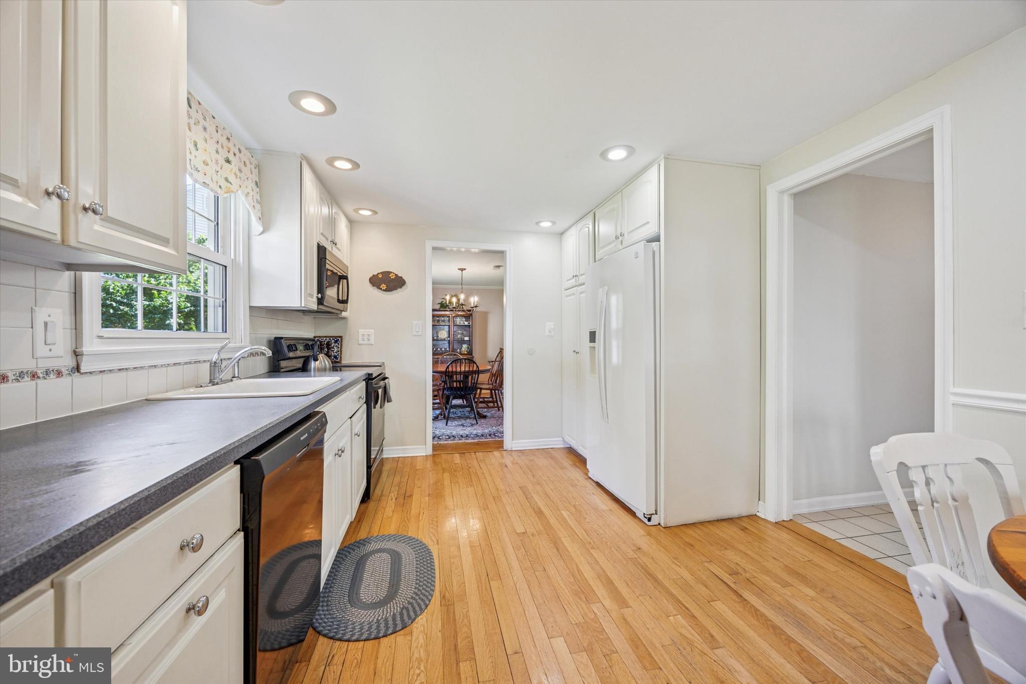 111 Wayside Drive Cherry Hill, NJ 08034 - Photo 7 of 28 a kitchen with stainless steel appliances granite countertop a sink and a refrigerator