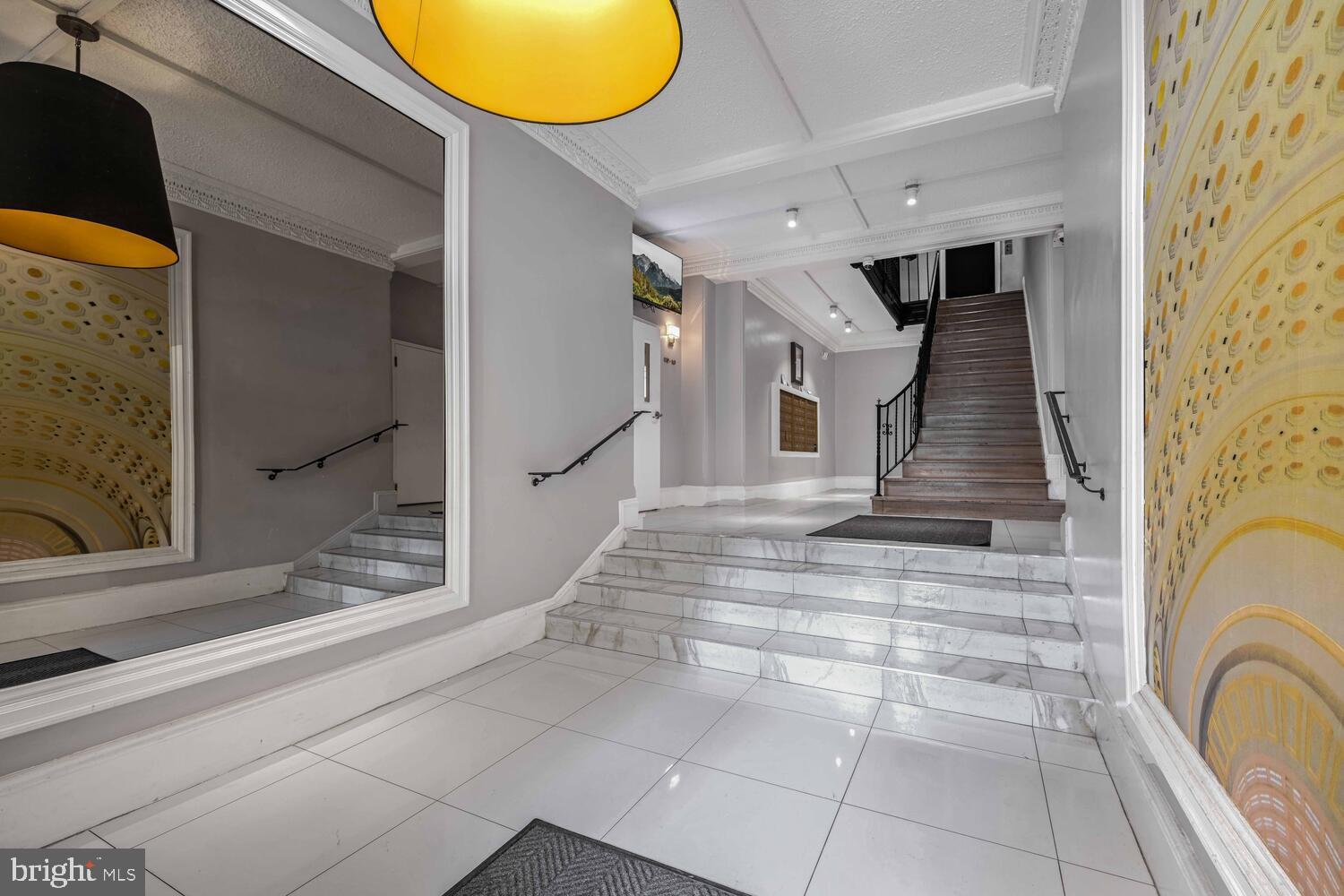 1401 Columbia Road Northwest, Unit 414 Washington, DC 20009 - Photo 2 of 18 Elegant entryway with striking staircase.