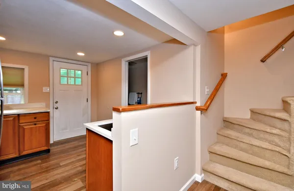 a kitchen with stainless steel appliances a sink a stove a refrigerator and cabinets