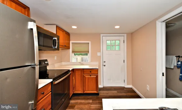 a kitchen with stainless steel appliances a refrigerator sink and microwave