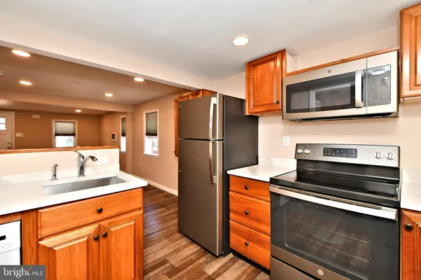a kitchen with stainless steel appliances granite countertop a refrigerator and a sink