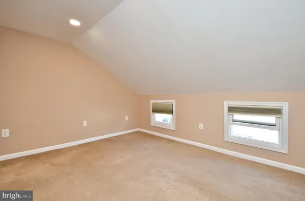 a bathroom with a granite countertop toilet sink and mirror