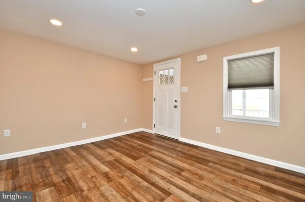 a view of room with window and wooden floor