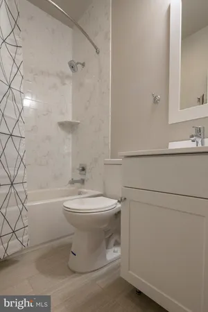 a bathroom with a toilet a sink and bathtub