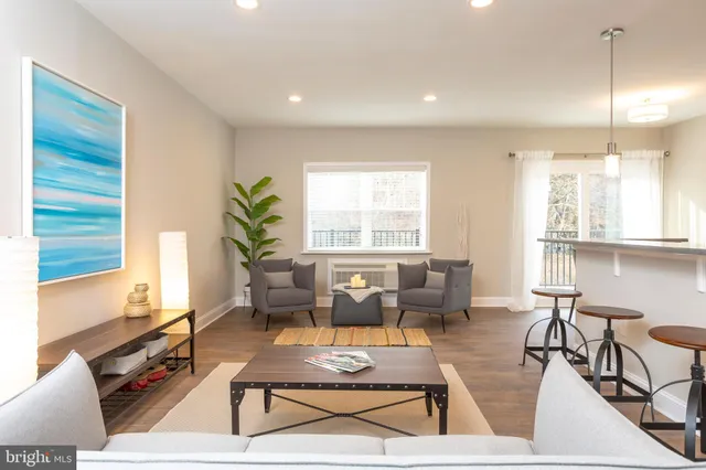 a living room with furniture a dining table and chairs with wooden floor