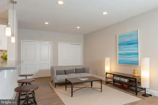 a living room with furniture a window and a table