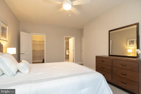 a bedroom with a bed and a dresser