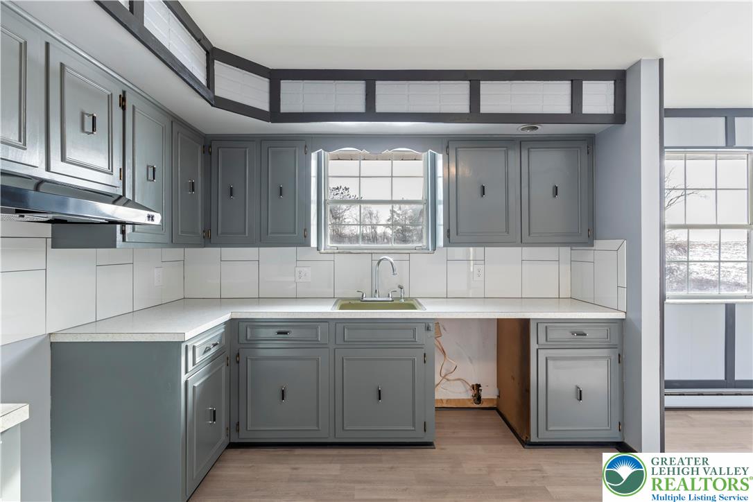 438 Nursery Road Kempton, PA 19529 - Photo 12 of 38 a kitchen with stainless steel appliances granite countertop a sink and cabinets with wooden floor