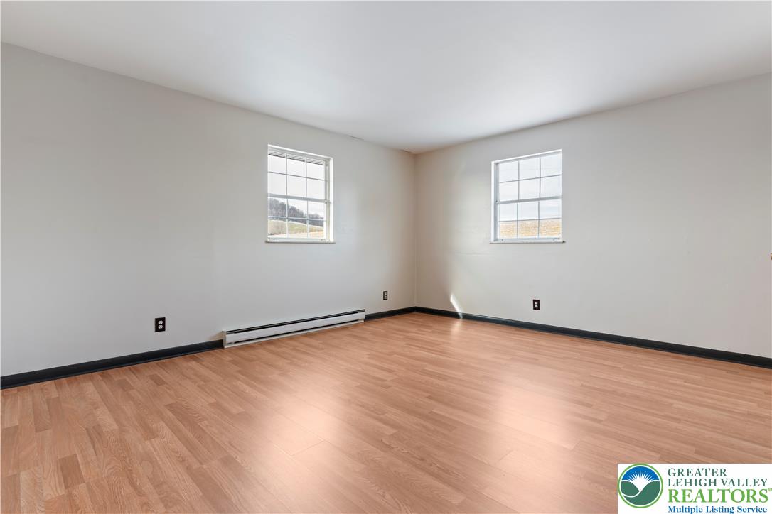 438 Nursery Road Kempton, PA 19529 - Photo 23 of 38 an empty room with wooden floor and windows