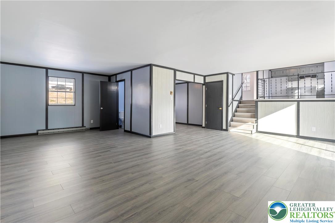 438 Nursery Road Kempton, PA 19529 - Photo 7 of 38 an empty room with wooden floor and windows