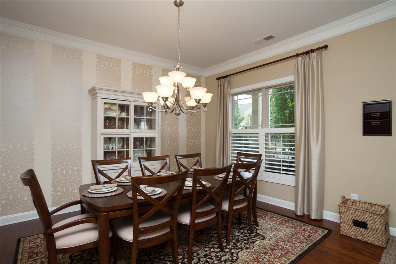 DINING ROOM WITH WAINSCOTING, CHANDELIER AND PLENTY OF ROOM FOR A LARGE TABLE. Dining