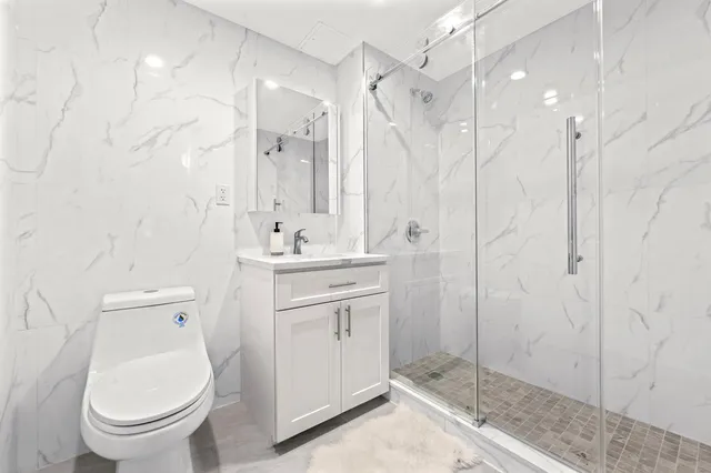 a bathroom with a toilet sink and shower