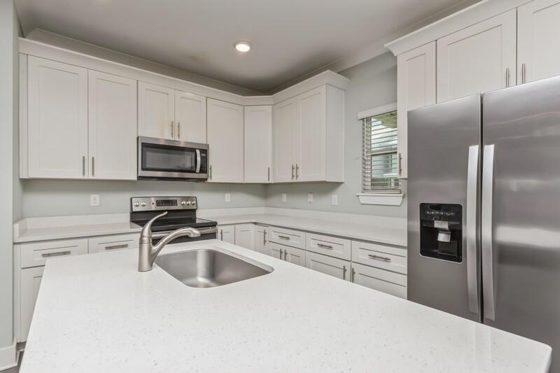 151 North Sand Palm Road, Unit 151 Freeport, FL 32439 - Photo 11 of 35 a kitchen with stainless steel appliances a refrigerator a sink a stove a microwave and cabinets