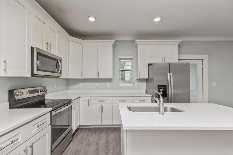 151 North Sand Palm Road, Unit 151 Freeport, FL 32439 - Photo 12 of 35 a kitchen with a sink cabinets and stainless steel appliances