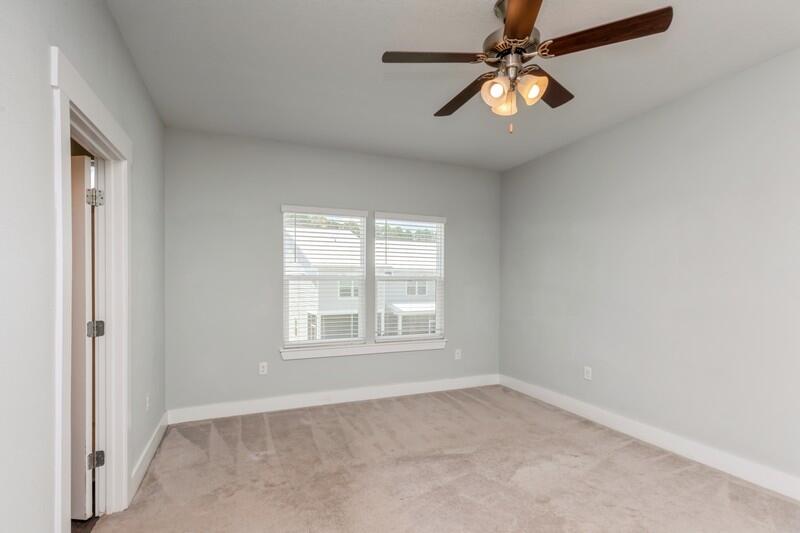 151 North Sand Palm Road, Unit 151 Freeport, FL 32439 - Photo 19 of 35 an empty room with windows and fan