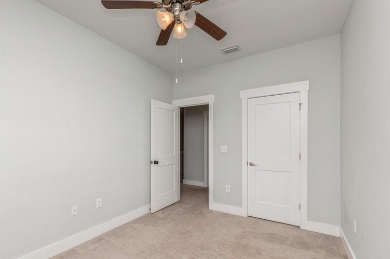 151 North Sand Palm Road, Unit 151 Freeport, FL 32439 - Photo 22 of 35 an empty room with a ceiling fan and a carpet