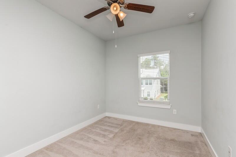151 North Sand Palm Road, Unit 151 Freeport, FL 32439 - Photo 24 of 35 an empty room with windows and chandelier fan