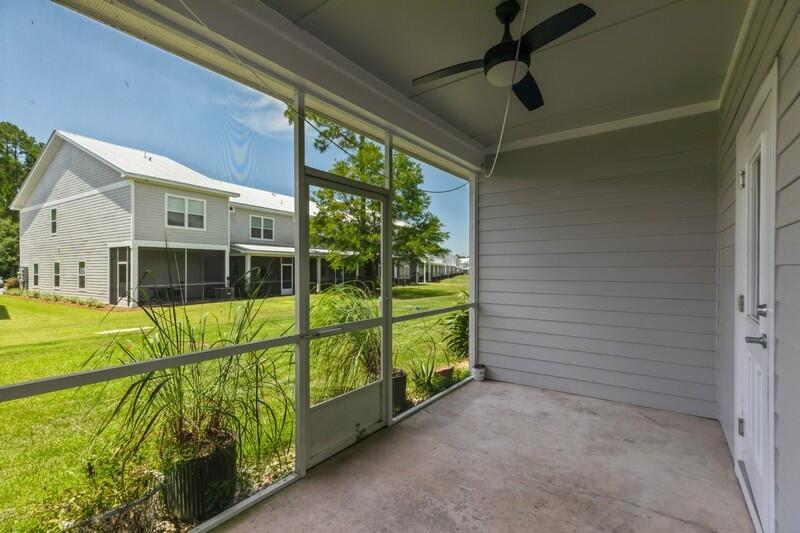 151 North Sand Palm Road, Unit 151 Freeport, FL 32439 - Photo 26 of 35 a view of a house with a large window and a yard