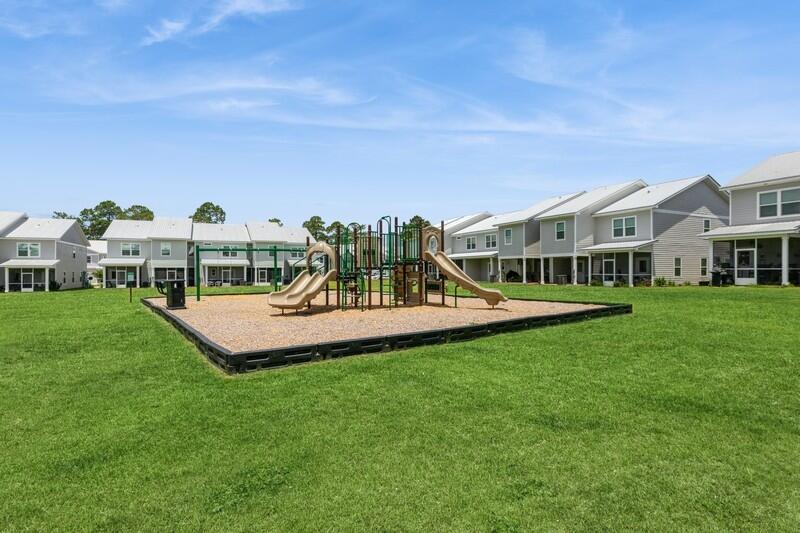 151 North Sand Palm Road, Unit 151 Freeport, FL 32439 - Photo 28 of 35 a view of a house with a yard and sitting area