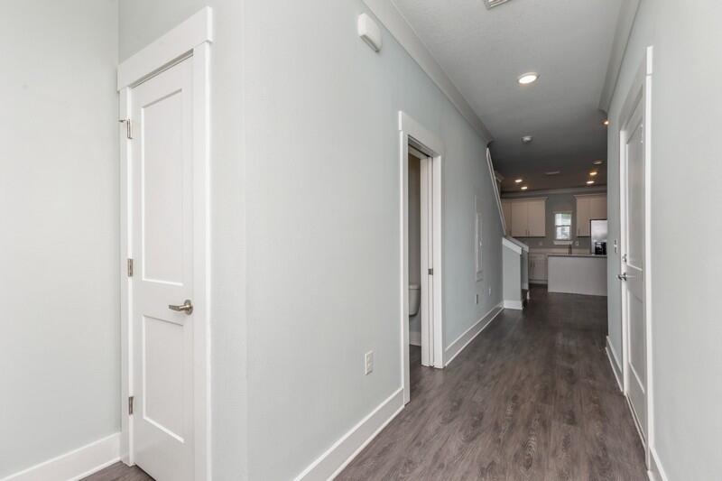151 North Sand Palm Road, Unit 151 Freeport, FL 32439 - Photo 3 of 35 a view of a hallway with wooden floor and a bathroom