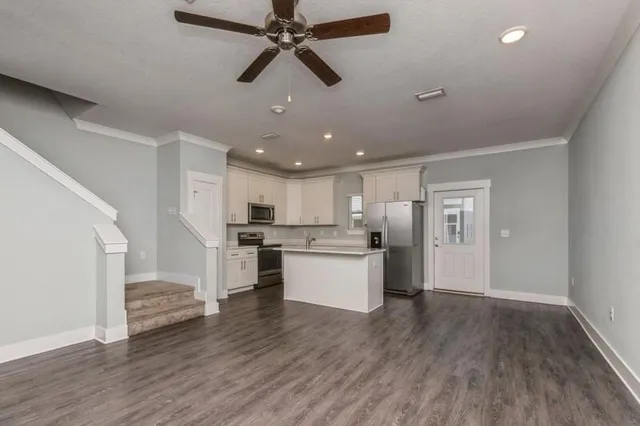 a view of kitchen with sink microwave and stove