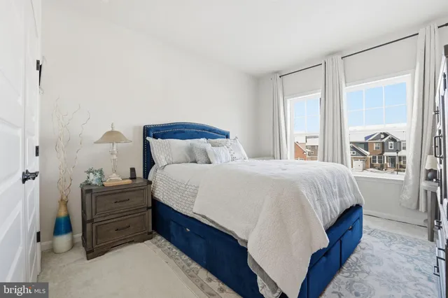 a bathroom with a sink a toilet a mirror and shower