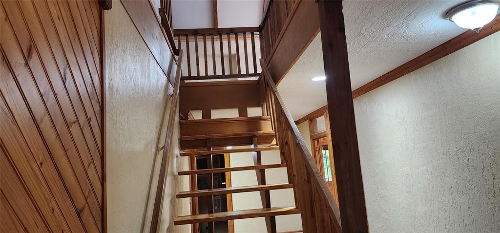 1992 County Road 330 Ranger, TX 76470 - Photo 17 of 40 a view of staircase with wooden floor and white walls