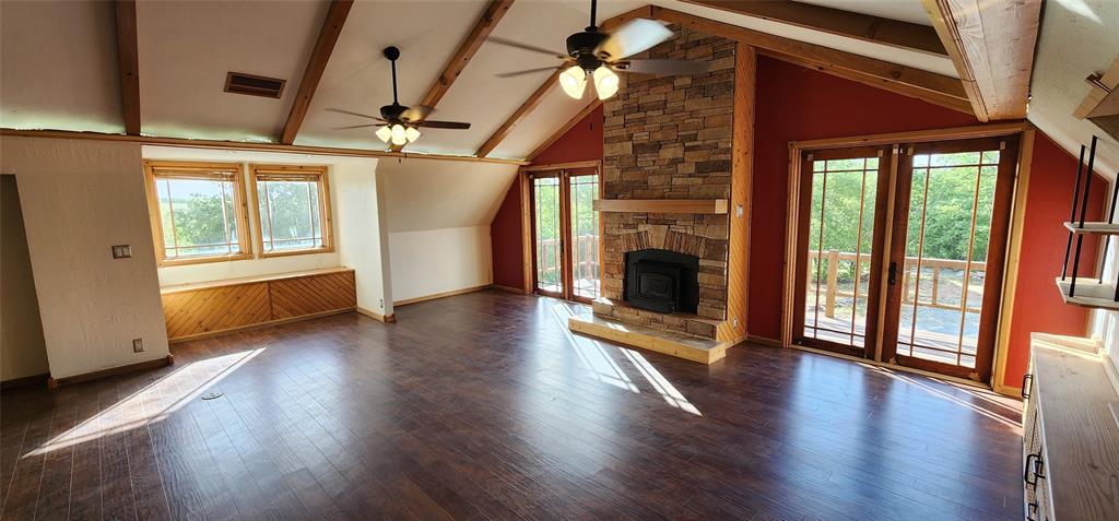 1992 County Road 330 Ranger, TX 76470 - Photo 18 of 40 a view of an empty room with wooden floor and a window