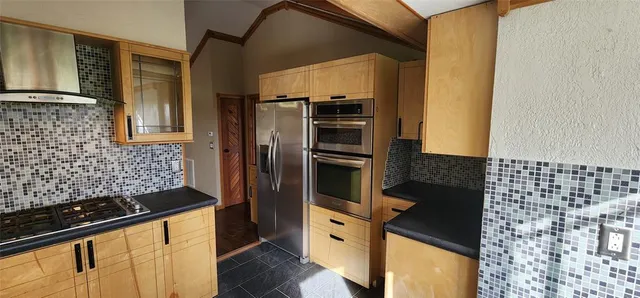 a kitchen with a refrigerator and a stove