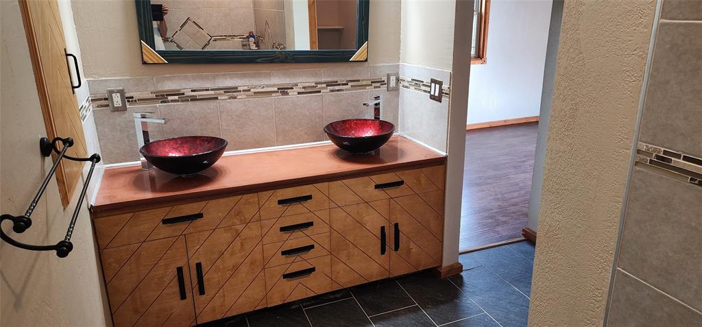 1992 County Road 330 Ranger, TX 76470 - Photo 28 of 40 a bathroom with a sink and a mirror