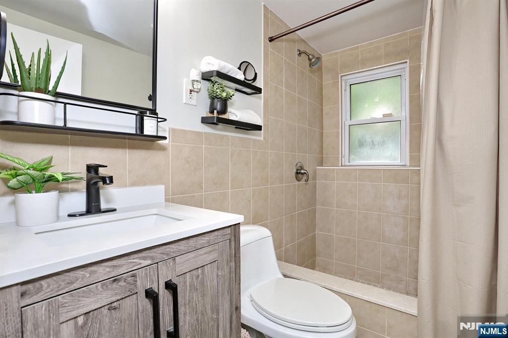 30 Brookfield Road Dumont, NJ 07628 - Photo 26 of 50 a bathroom with a sink a toilet and shower