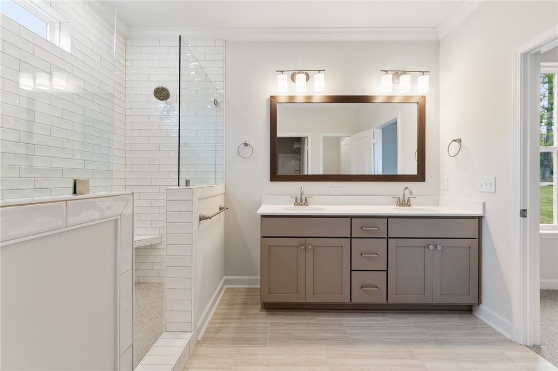 110 Lakeside Drive Anderson, SC 29621 - Photo 22 of 34 This spacious bathroom offers a double vanity and a glass-enclosed shower.