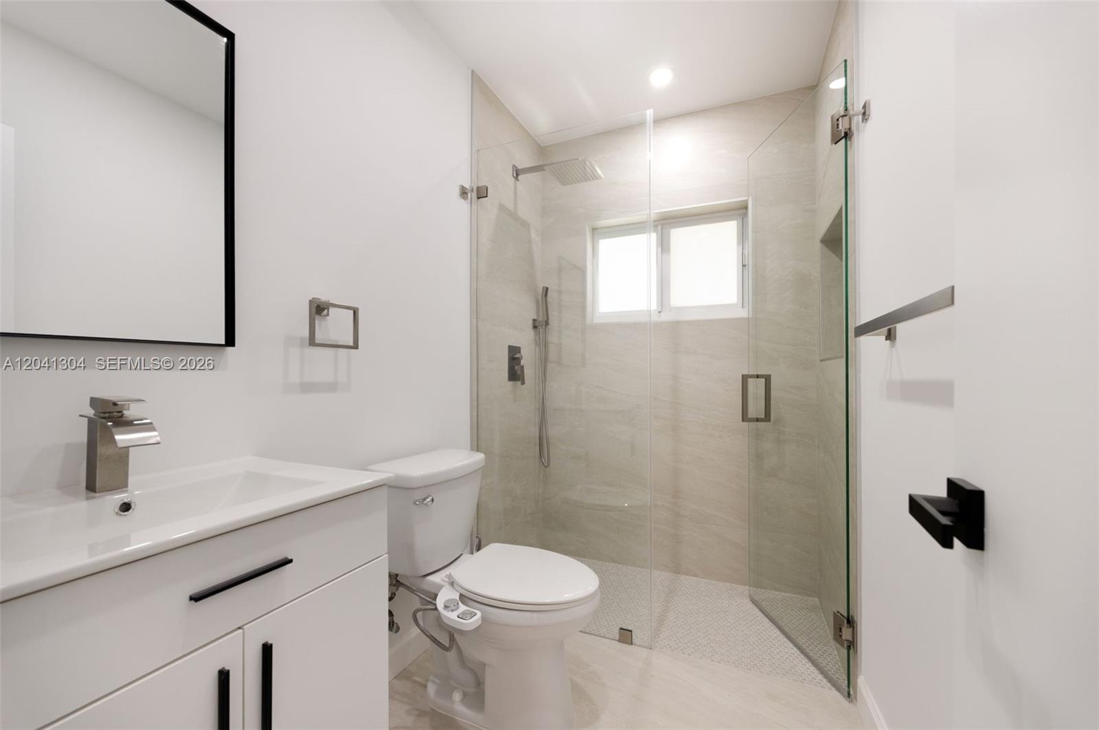 10340 Southwest 157th Street Miami, FL 33157 - Photo 14 of 24 Bathroom – Beautifully updated bathroom showcasing a frameless glass walk-in shower, contemporary fixtures, and elegant tile finishes. A sleek, spa-inspired design with a clean, modern feel.
