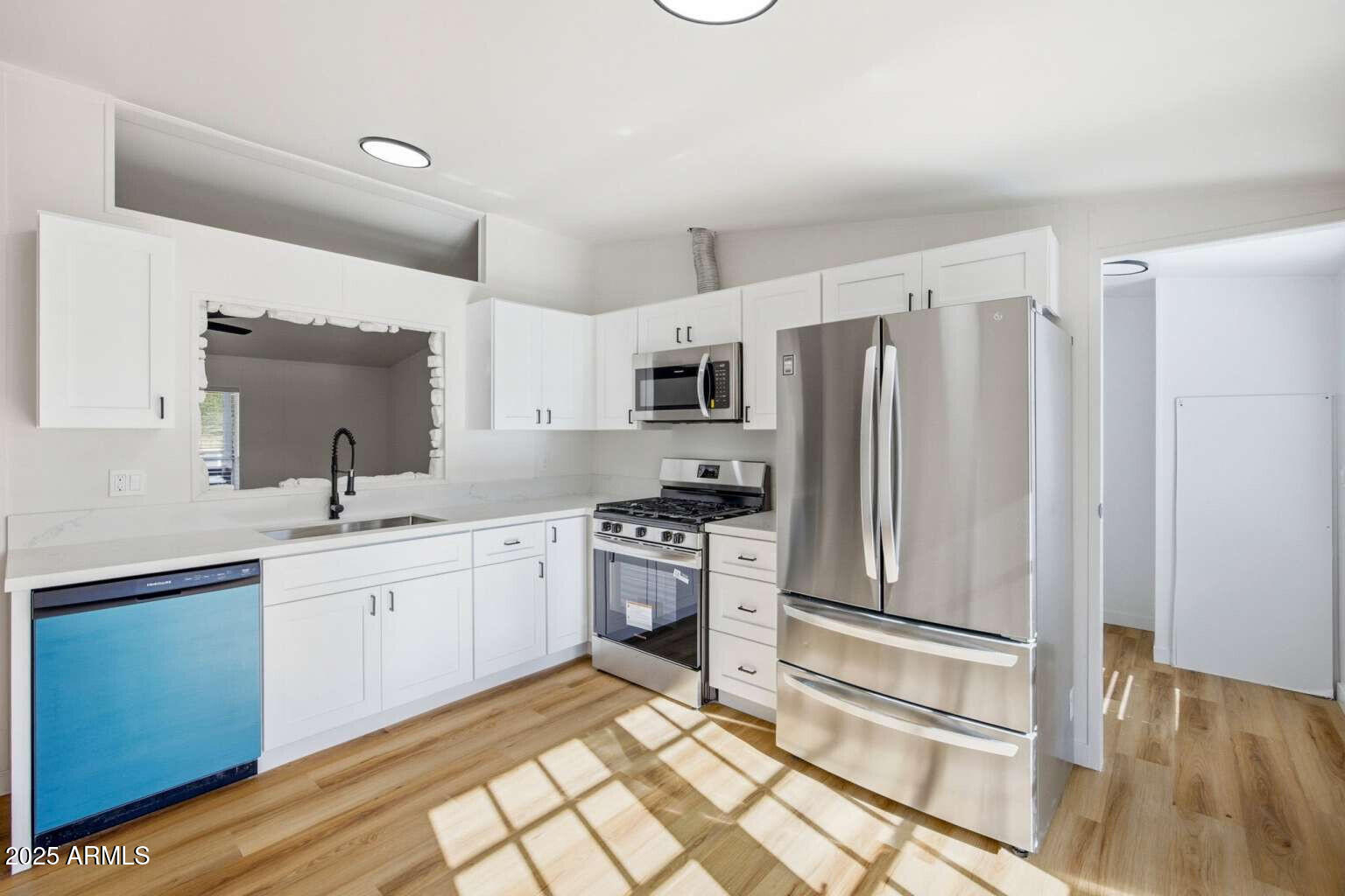 705 East Cherry Street Payson, AZ 85541 - Photo 11 of 35 a kitchen with a sink stainless steel appliances and cabinets