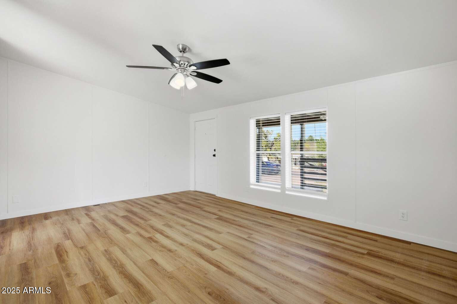 705 East Cherry Street Payson, AZ 85541 - Photo 9 of 35 a view of empty room with wooden floor and fan