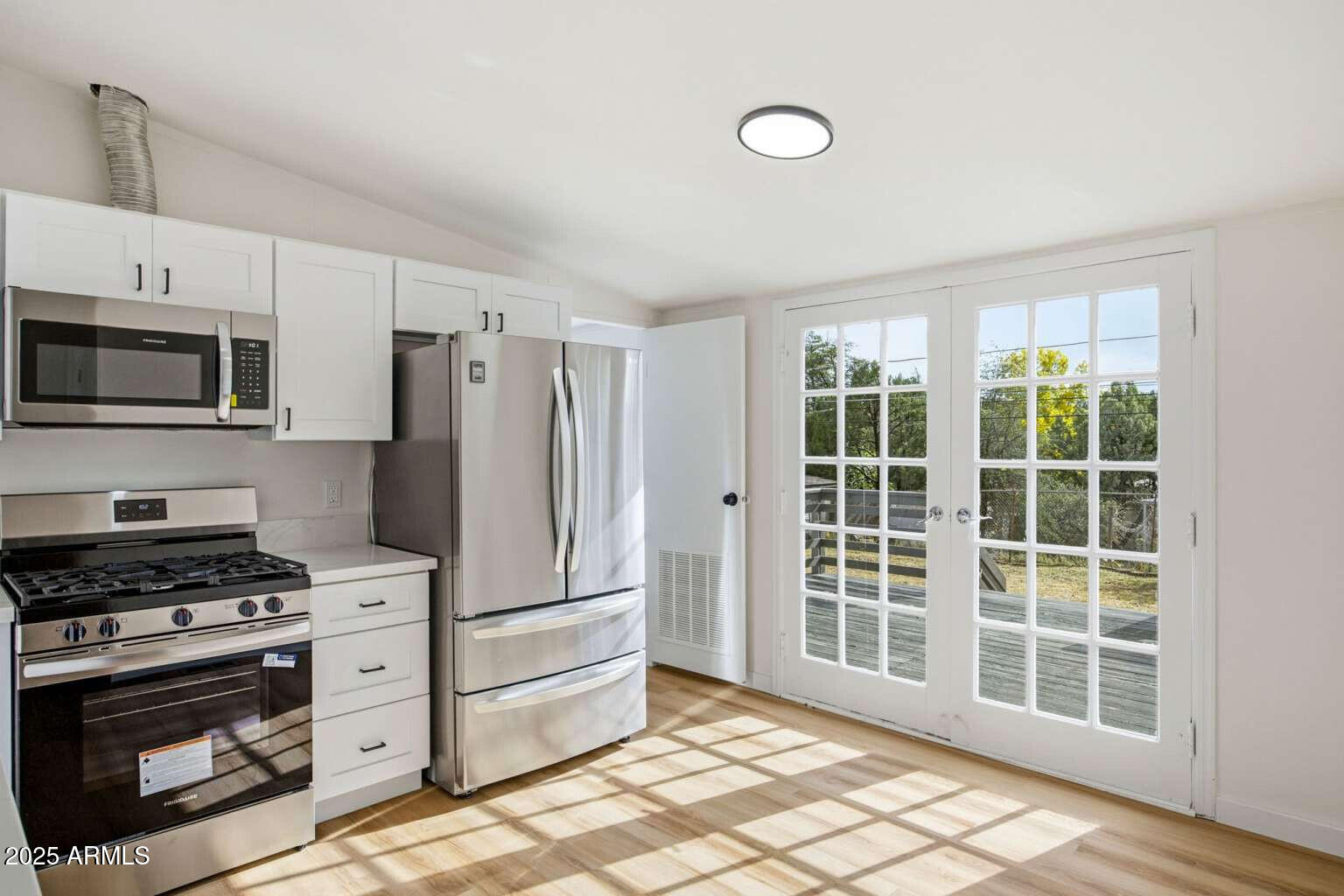 705 East Cherry Street Payson, AZ 85541 - Photo 10 of 35 a kitchen with stainless steel appliances a stove a microwave and a refrigerator