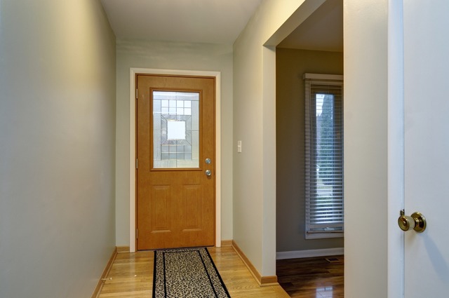 467 Sheffield Road Naperville, IL 60565 - Photo 2 of 19 a view of a hallway with wooden floor and a bathroom