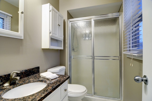 467 Sheffield Road Naperville, IL 60565 - Photo 12 of 19 a bathroom with a granite countertop sink toilet a mirror and shower