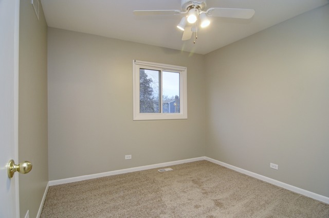 467 Sheffield Road Naperville, IL 60565 - Photo 15 of 19 an empty room with a chandelier fan