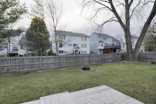 467 Sheffield Road Naperville, IL 60565 - Photo 17 of 19 a view of a backyard with wooden fence and a large tree