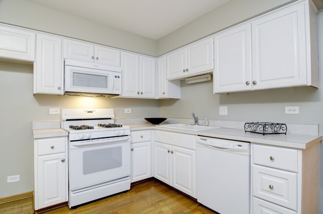467 Sheffield Road Naperville, IL 60565 - Photo 6 of 19 a kitchen with white cabinets and white appliances